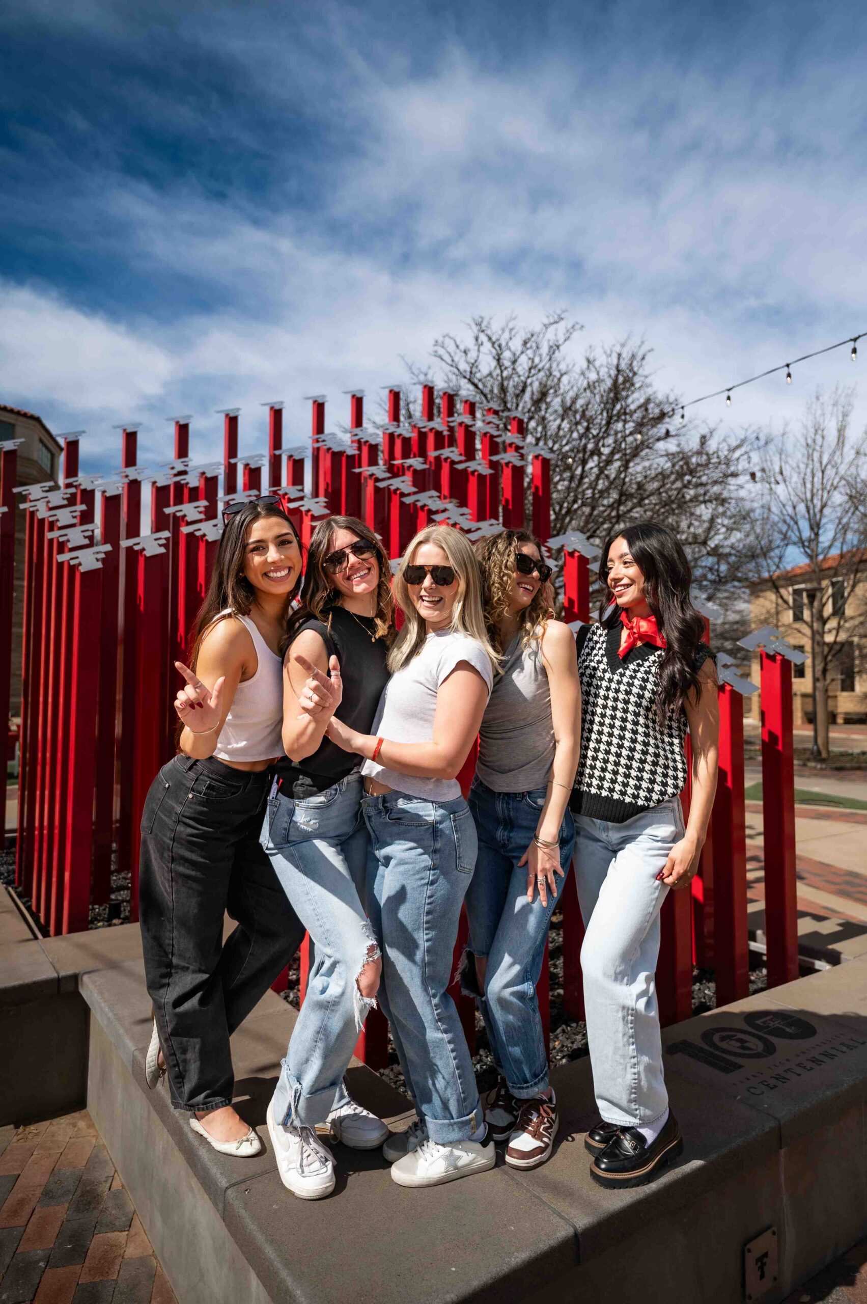 five women at texas tech university sculpture near troubadour in lubbock tx scaled
