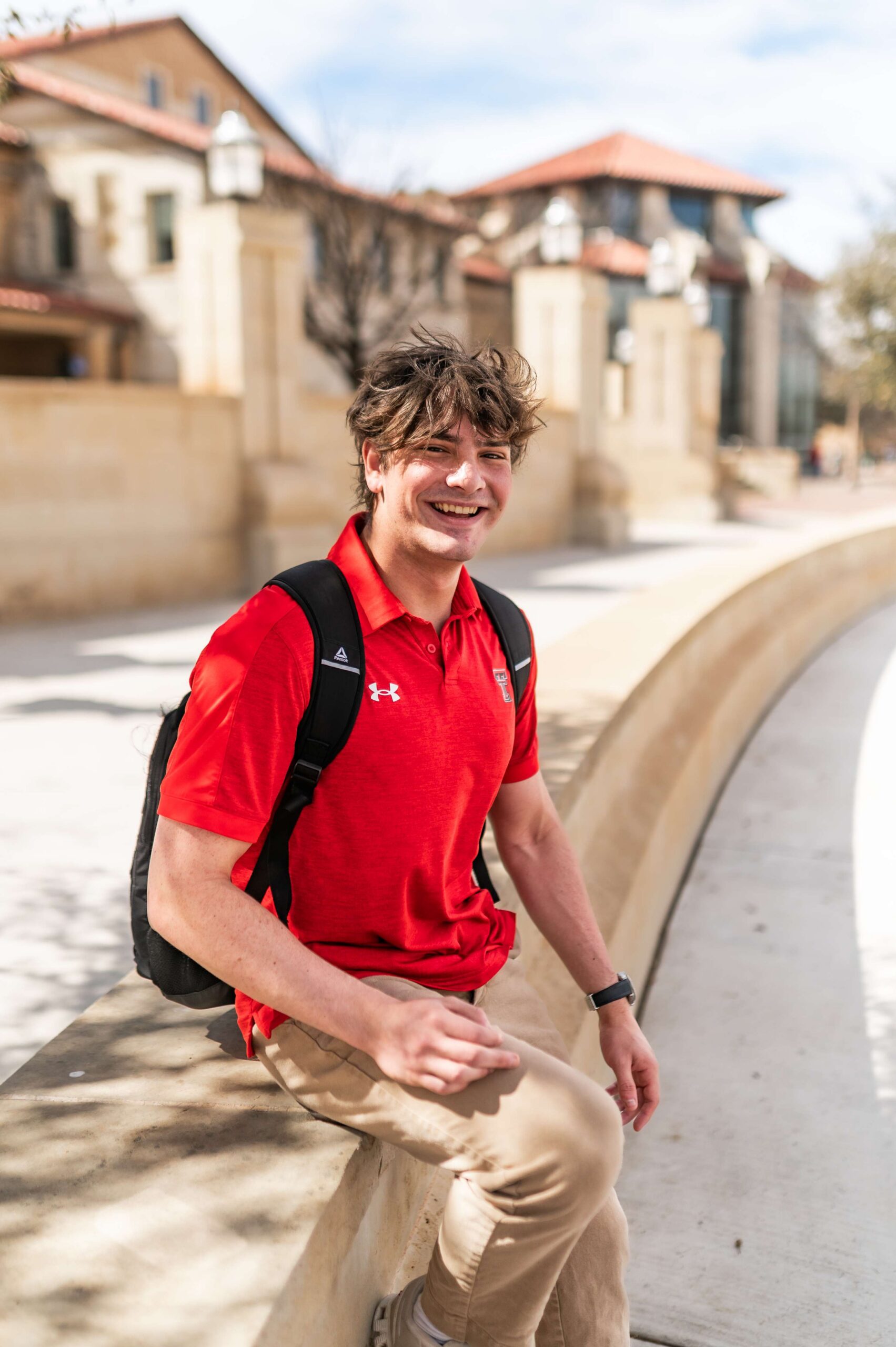student smiling on campus near troubadour in lubbock tx scaled