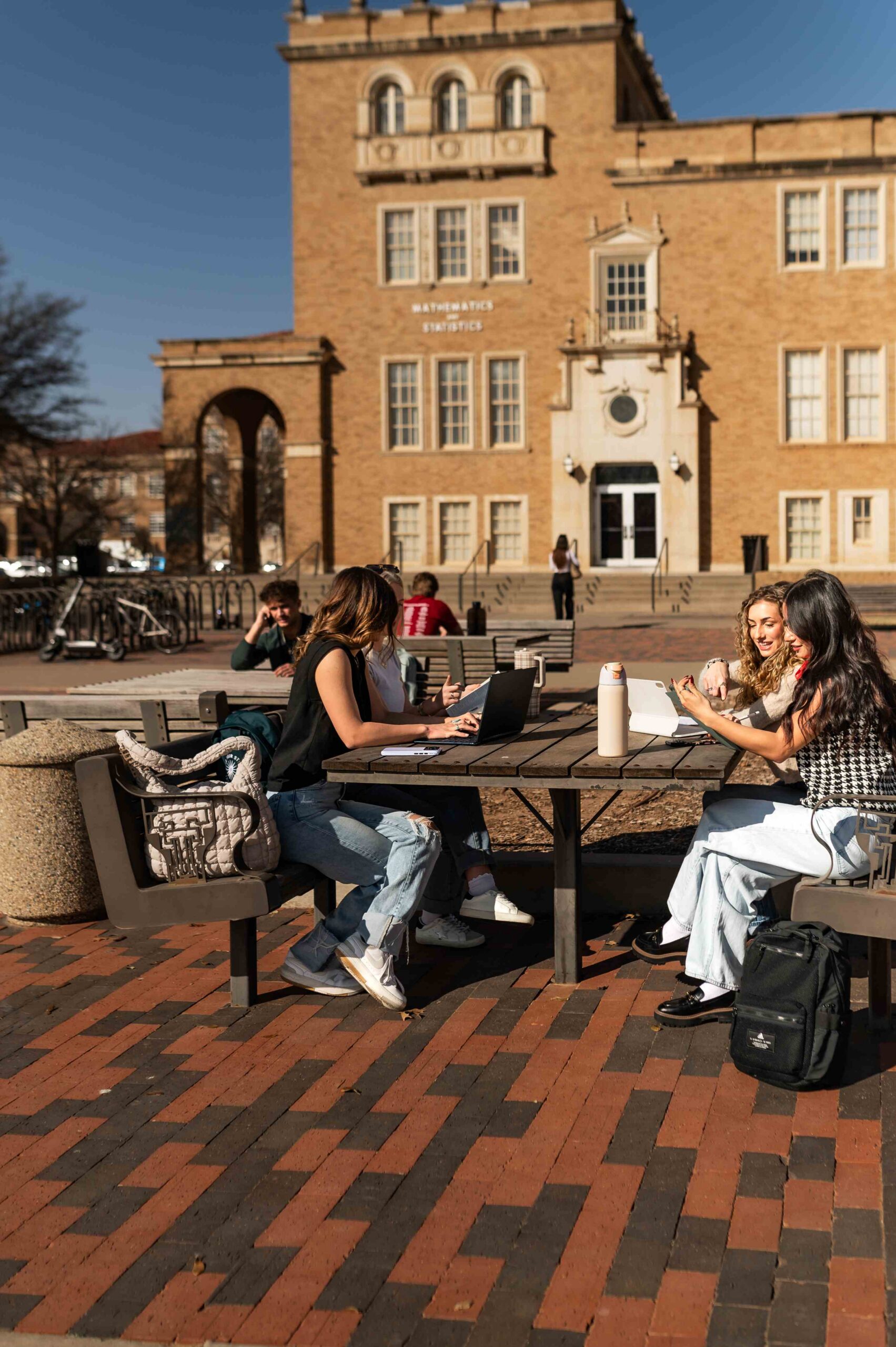 students studying outdoors on campus near troubadour in lubbock tx scaled