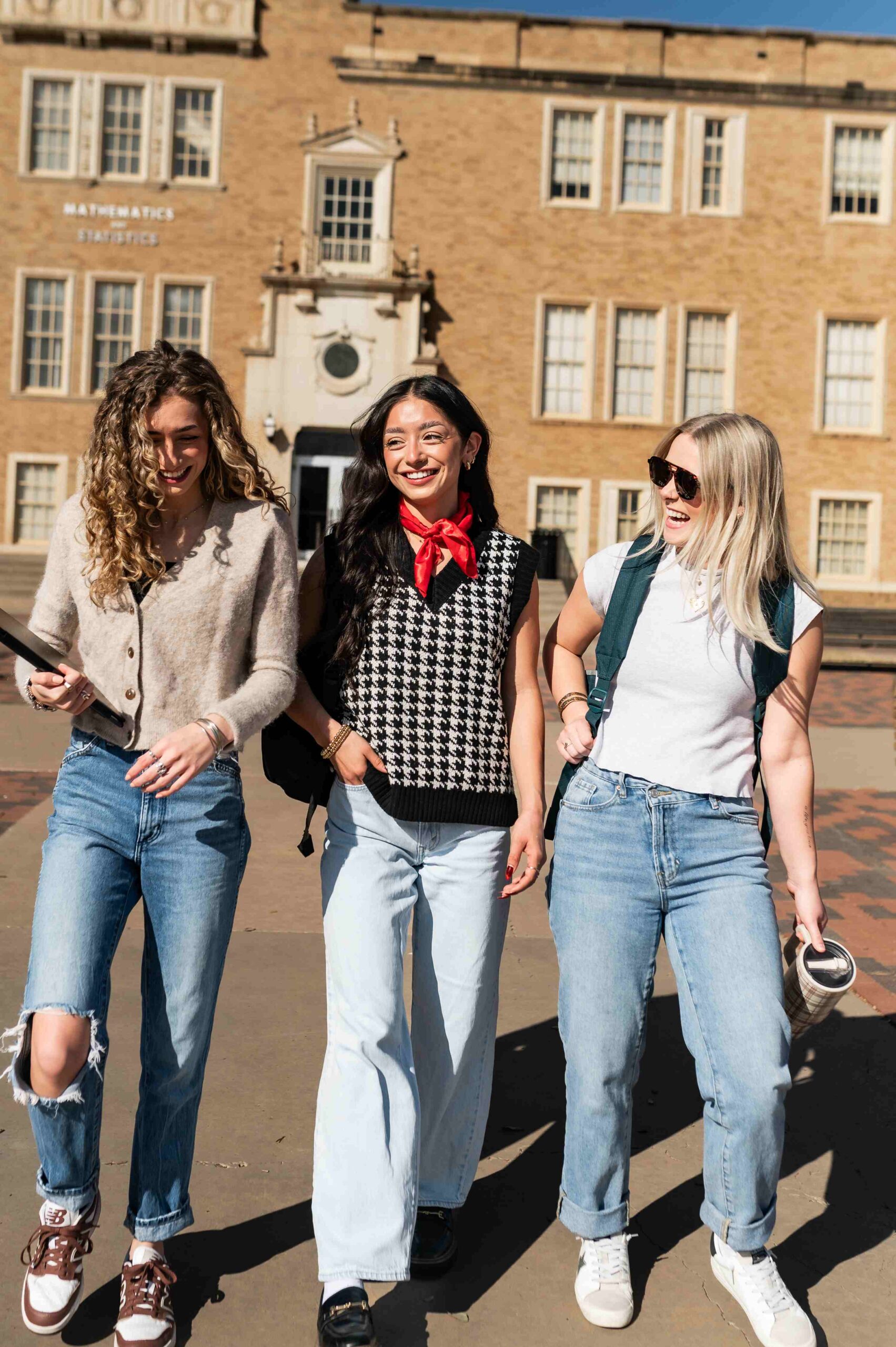 three female students walking on campus near troubadour in lubbock tx scaled